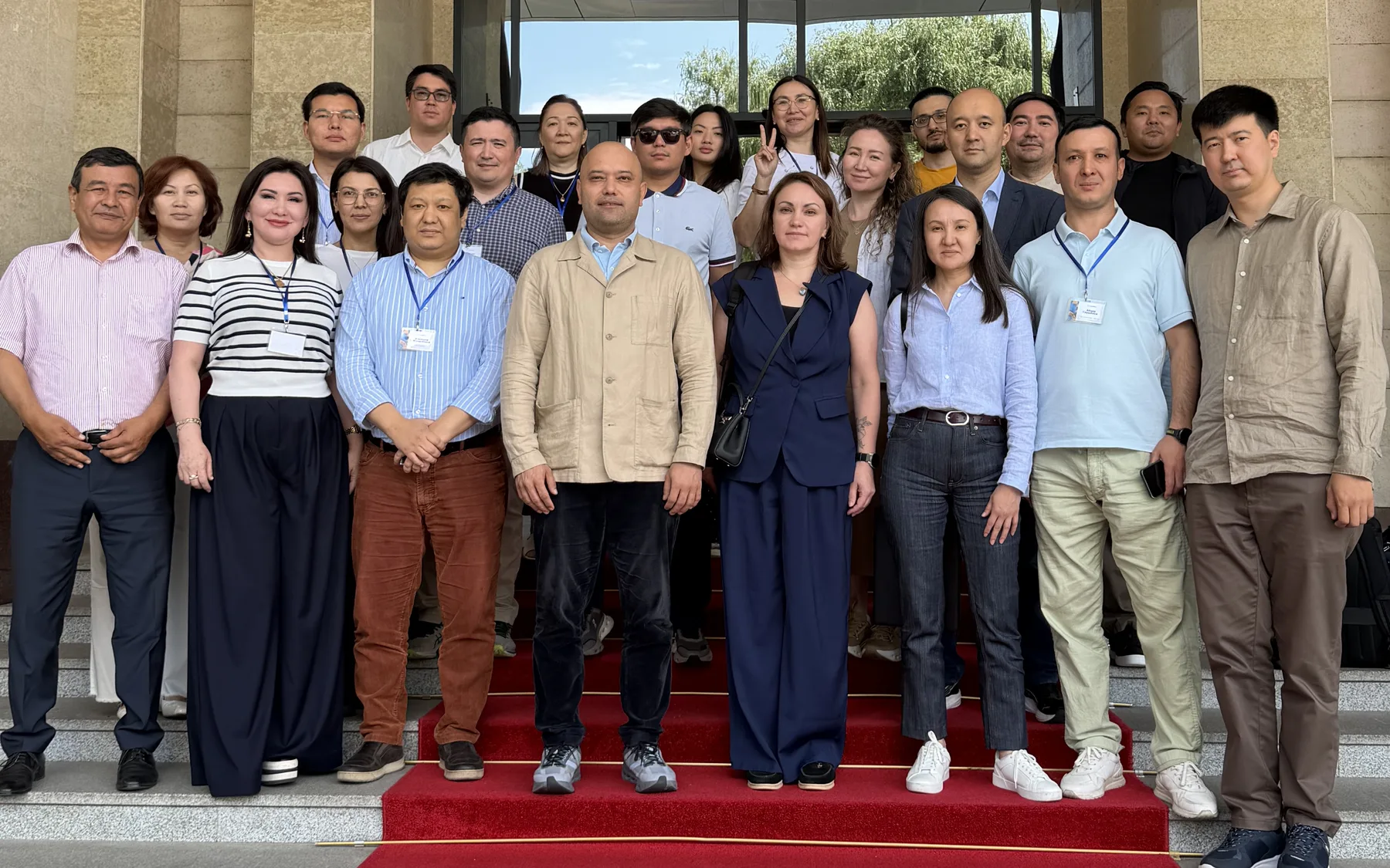 Participants of the Kazatomprom finance AI seminar on the steps of a hotel in Almaty